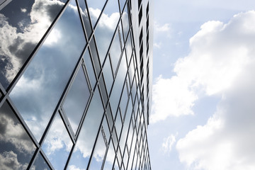 Wolken spiegeln sich in Fassade aus Glas