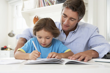 Fototapeta na wymiar Father Helping Son With Homework