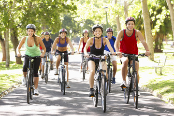 Group Of Cyclists On Cycle Ride Through Park