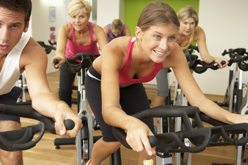 Group Taking Part In Spinning Class In Gym