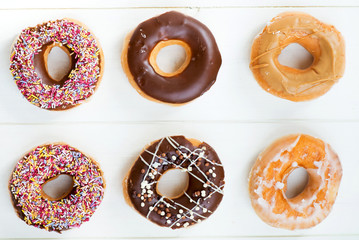 Glazed Doughnuts with colourful sprinkles, chocolate, icing