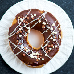 Glazed Doughnuts with chocolate and icing on white Plate