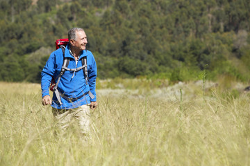 Naklejka na ściany i meble Senior Man On Hike Through Beautiful Countryside