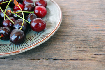 fresh fruits background with sweet cherries on rustic wooden table