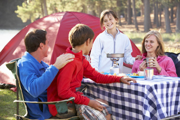 Family Enjoying Meal On Camping Holiday