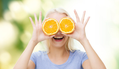 happy woman having fun covering eyes with orange