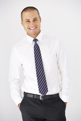 Studio Portrait Of Businessman Standing Against White Background