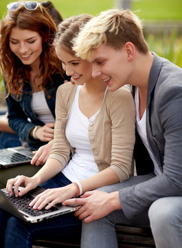students or teenagers with laptop computers