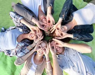 group of students or teenagers lying in circle