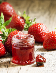 Fresh homemade strawberry jam with berries in small jars, select