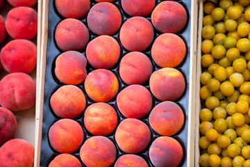 Fresh peaches and plums selling in a market