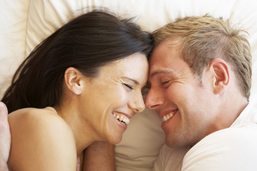 Couple Relaxing In Bed