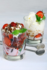 Healthy layered  desserts with fresh strawberries and cream on wooden 