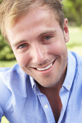 Fototapeta premium Head And Shoulders Portrait Of Smiling Man