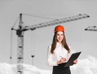 Smiling woman-builder in hardhat 