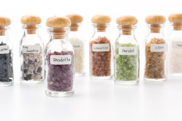 rhodolite in glass bottle isolated on white background