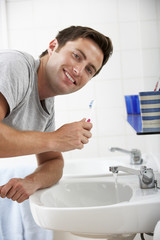Man In Bathroom Brushing Teeth