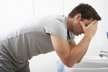 Fototapeta premium Tired Man In Standing At Bathroom Sink