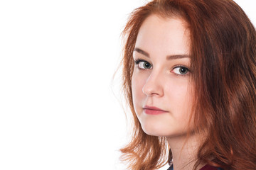 Obraz premium Close-up portrait of a beautiful young red-haired girl looking a