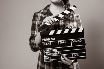 Close-up of a girl with a movie clapper.