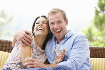 Fototapeta premium Couple Sitting On Outdoor Seat Together