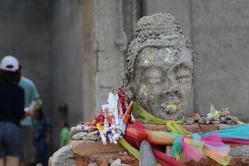 Ancient buddha head statue in old temple, Kanchanaburi, Thailand.
