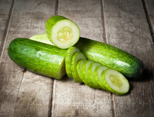 cucumber slices on wooden background