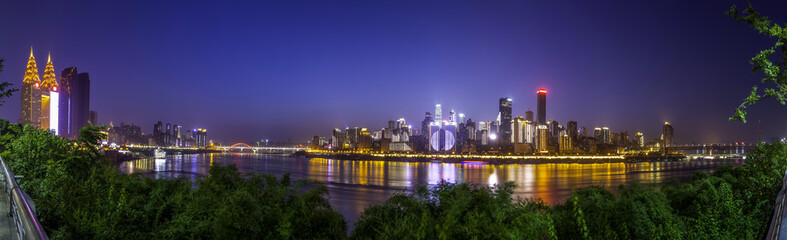 illuminated skyline of chongqing at riverbank