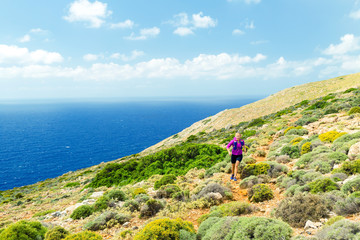 Trail running happy woman in beautiful mountains