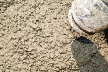 Street worker pouring cement with a pump