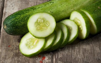 cucumber slices on wooden background