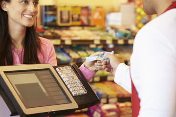 Customer Paying For Shopping At Checkout With Card