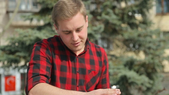 Close-up of a guy in a plaid shirt beating on a drum