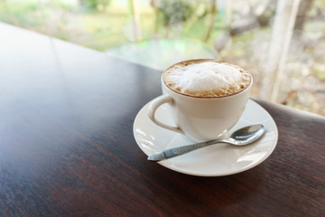 coffee cup on wooden table, hot latte