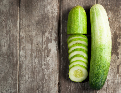 Cucumber Slices On Wooden Background