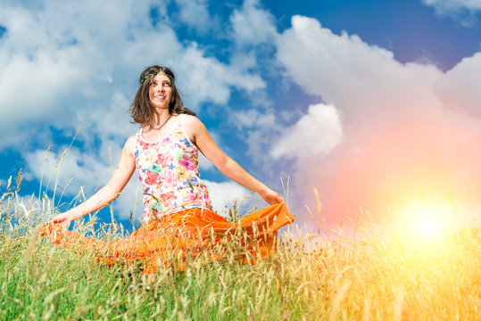 Hippie girl in a spring meadow strong colors