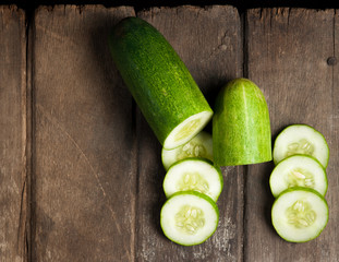 cucumber slices on wooden background