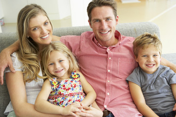 Family Relaxing On Sofa Together