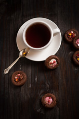 cup of coffee and cookie on wood table