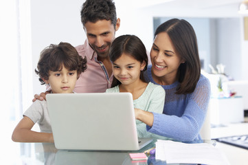Family Working At Laptop With In Home Office