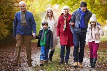 Multl Generation Family Walking Along Autumn Path