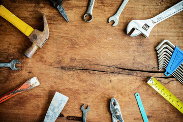 Set of work tools on old grunge wooden background