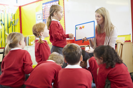 Teacher Teaching Spelling To Elementary School Pupils