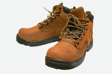 Safety boots isolated on white background, close up new boots on white background, Worker used boots shoe in heavy industry for protected them foot.