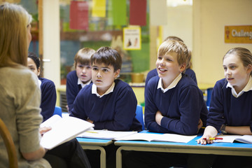 Teacher Teaching Lesson To Elementary School Pupils