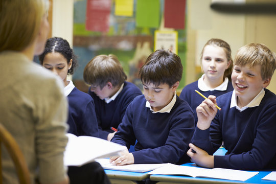 Teacher Teaching Lesson To Elementary School Pupils