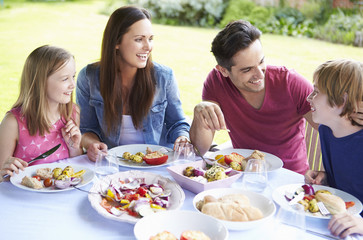 Family Enjoying Outdoor Meal Together