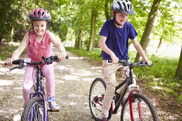 Two Children On Cycle Ride In Countryside