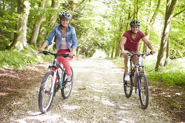 Fototapeta premium Young Couple On Cycle Ride In Countryside