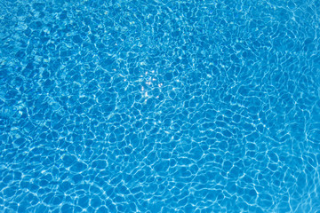 Fototapeta na wymiar Blue and Bright water surface in swimming pool